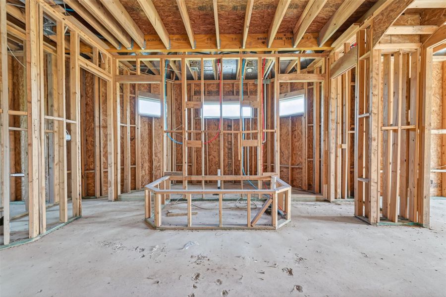 Open unfinished space showcasing framing and build progress.