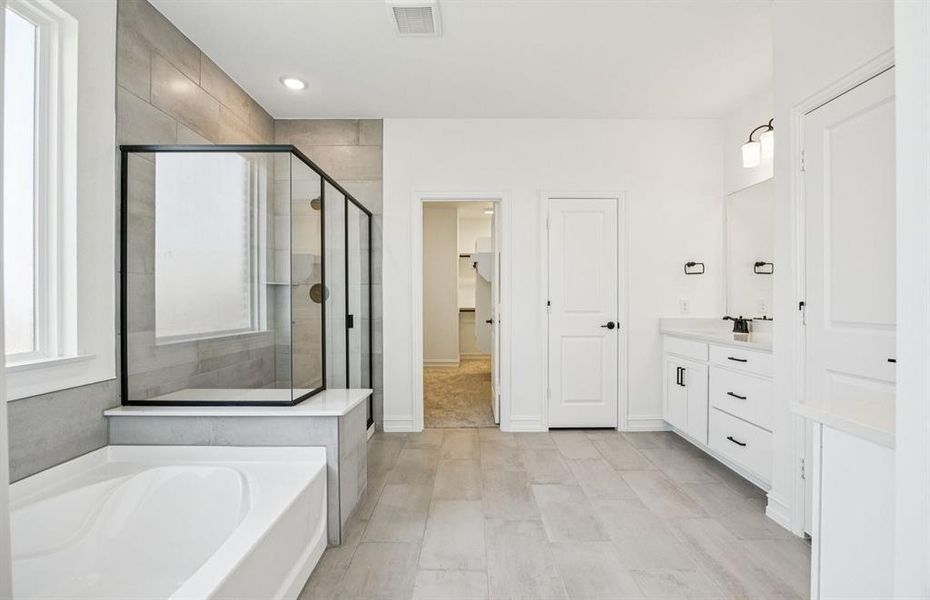 Luxurious owner's bath complete with double sinks and a generous shower Luxurious owner's bath complete with double sinks and a generous shower