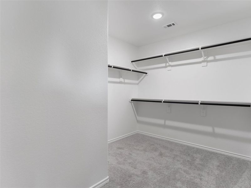 Spacious master closet with convenient built-in shelving. Spacious master closet with convenient built-in shelving.