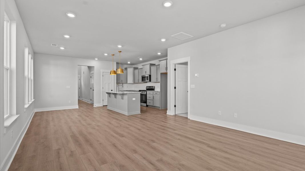 Elegant family room with hardwood flooring and open-concept flow in this first-class DRB Homes design