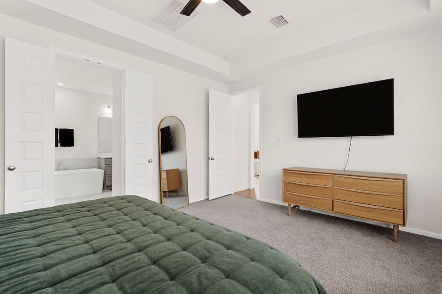 Primary bedroom view showing the entrance to the spa-like ensuite bath. Primary bedroom view showing the entrance to the spa-like ensuite bath.