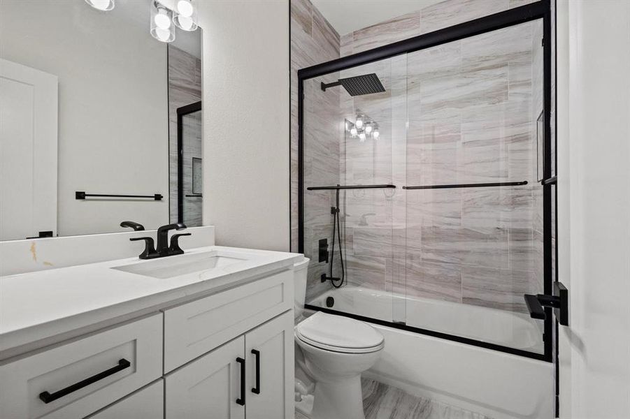 Full bath featuring vanity and combined bath / shower with glass door