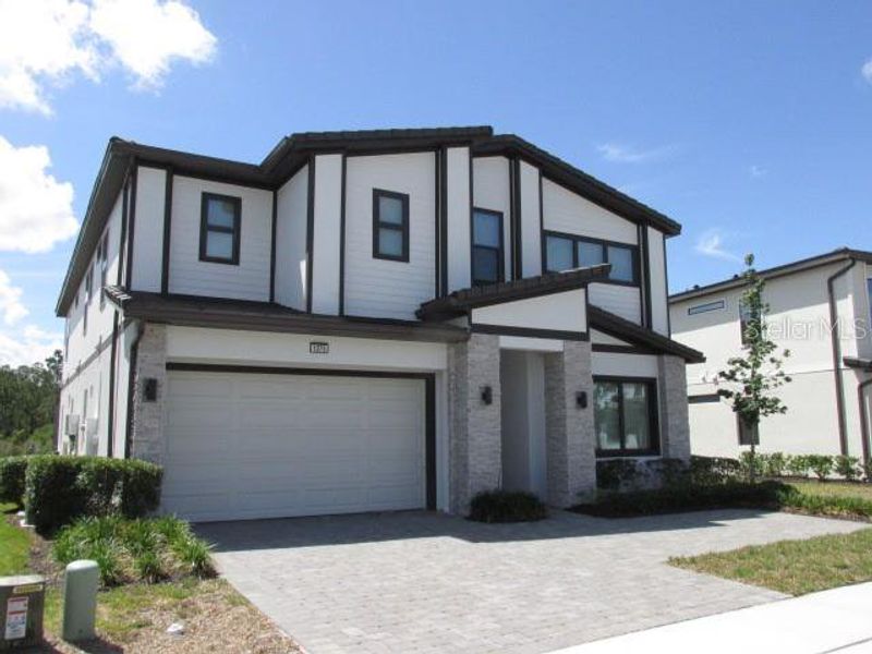 Front exterior of a new home in , Davenport, FL, highlighting curb appeal (Image 1). Front exterior of a new home in , Davenport, FL, highlighting curb appeal (Image 1).