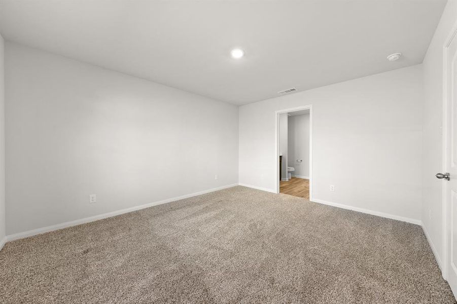 Unfurnished room featuring light carpet