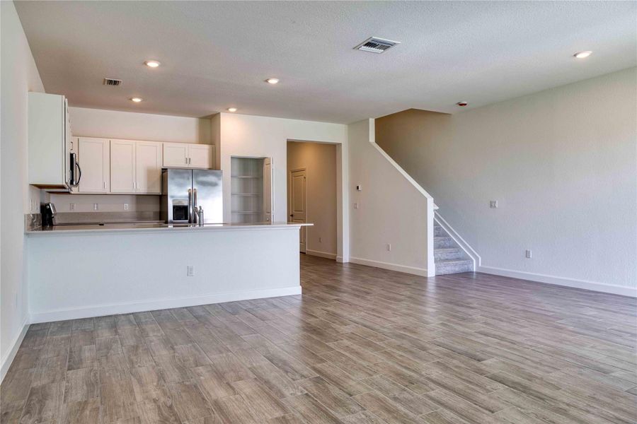 Wood looking tile flooring throughout 1st floor with a gray tone