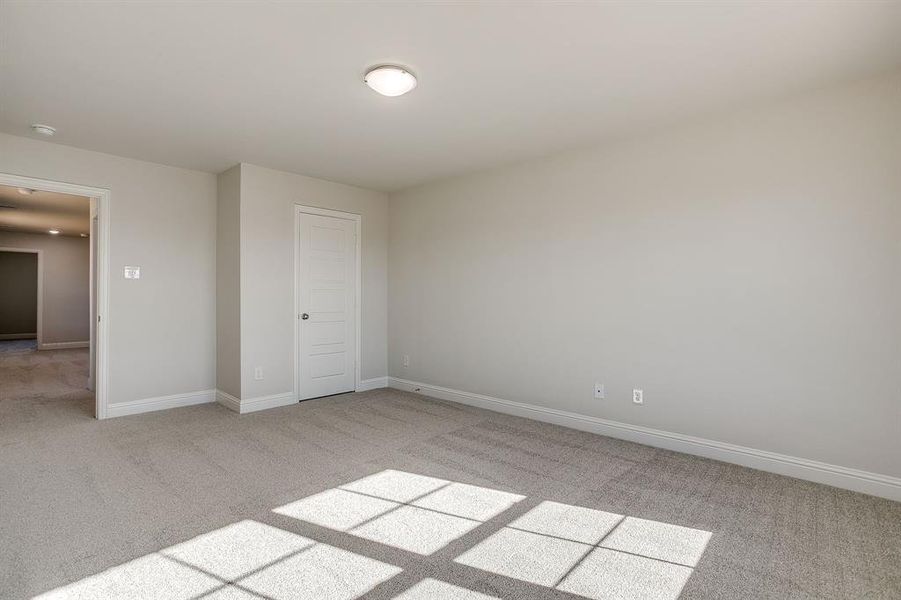 Unfurnished bedroom with light carpet
