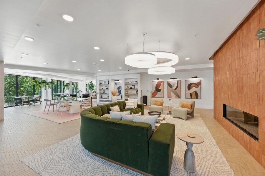 An inviting common area offers ample space for relaxation and social gatherings, featuring contemporary lighting and warm textures.