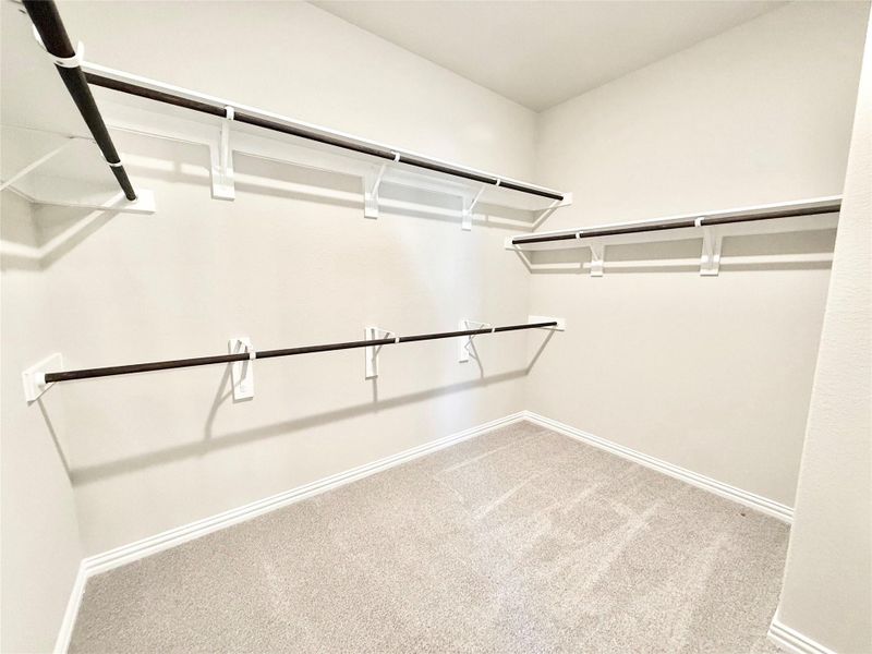 Walk in closet with light carpet Walk in closet with light carpet