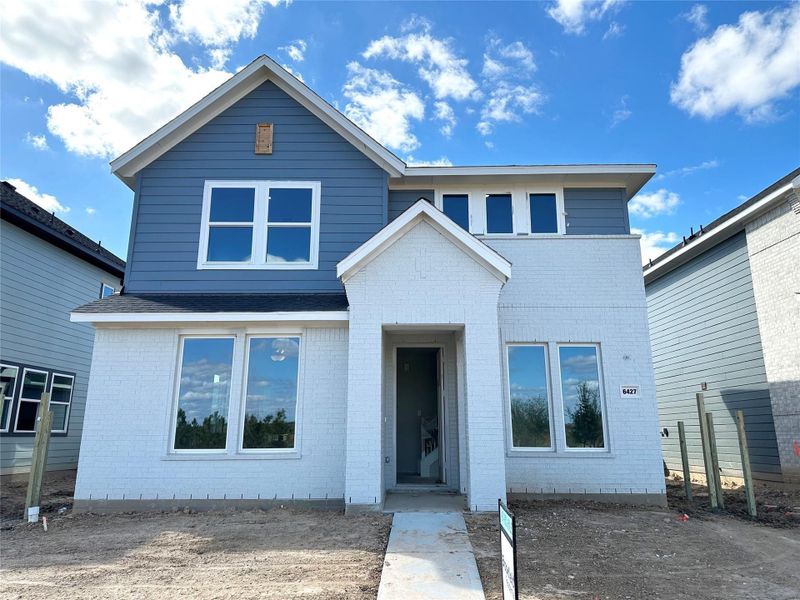 Front exterior of a new home in Elyson, Katy, TX, highlighting curb appeal (Image 17).