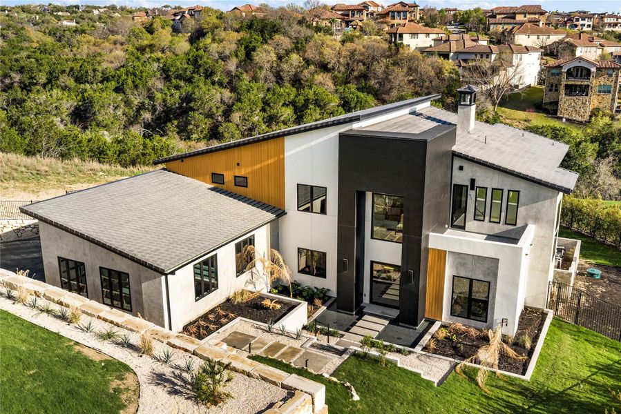 View of front of home featuring a chimney, stucco siding, roof with shingles, and a residential view View of front of home featuring a chimney, stucco siding, roof with shingles, and a residential view