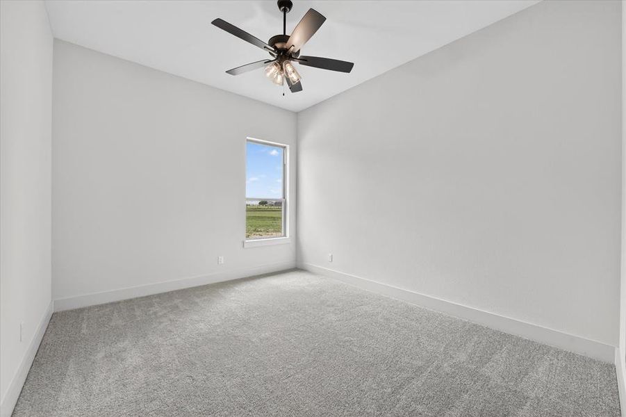 Spare room with carpet floors and a ceiling fan