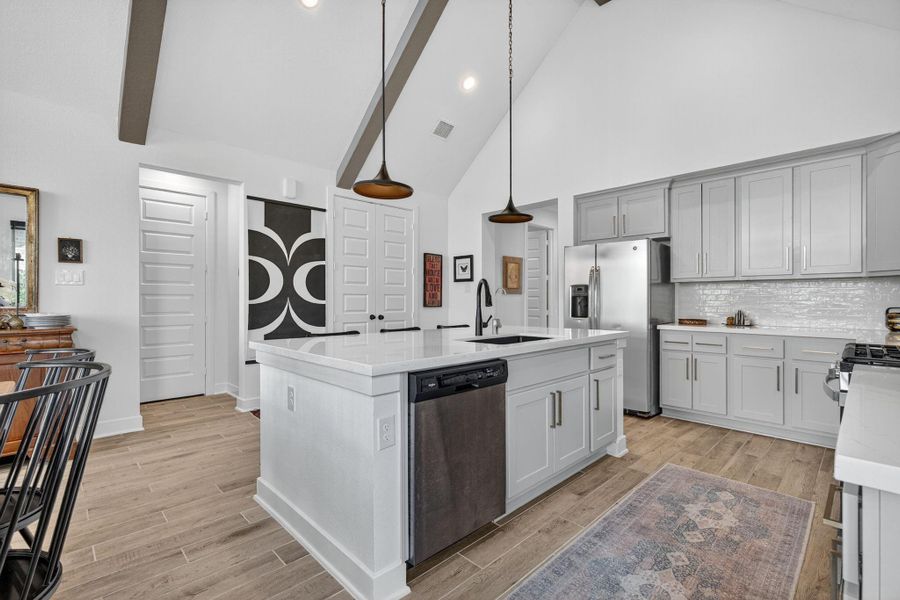 The large island features quartz countertops and extra seating! 31418 Golden Cliffs Ln., Fulshear, TX 77441 The large island features quartz countertops and extra seating! 31418 Golden Cliffs Ln., Fulshear, TX 77441