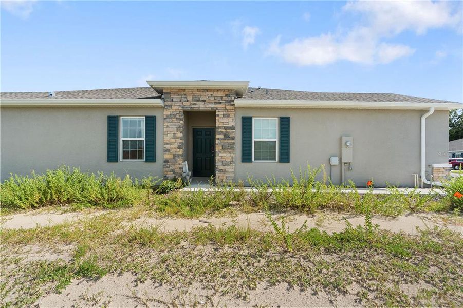 Front exterior of a new home in Park Ridge Villas, Spring Hill, FL, highlighting curb appeal (Image 24).