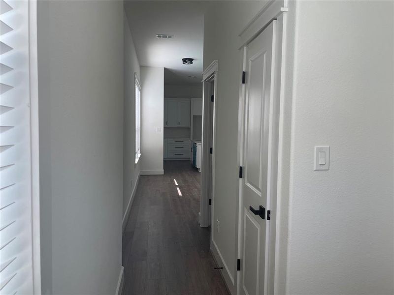Hallway with baseboards and dark wood finished floors