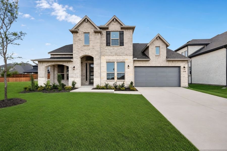 Front exterior of a new home in Highland Lakes, McKinney, TX, highlighting curb appeal (Image 2). Front exterior of a new home in Highland Lakes, McKinney, TX, highlighting curb appeal (Image 2).