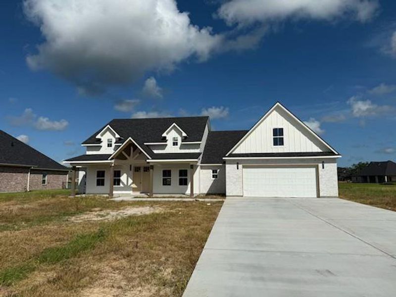 Front exterior of a new home in , Angleton, TX, highlighting curb appeal (Image 1).