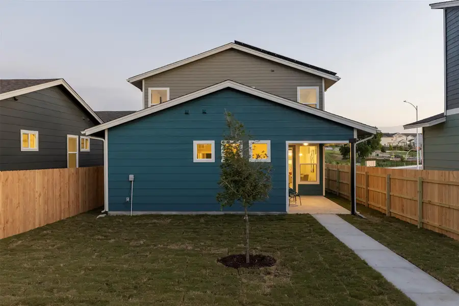 Rear view of property with a fenced backyard