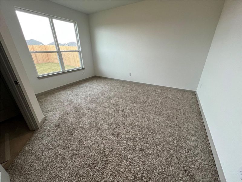 Unfurnished room with carpet flooring and baseboards Unfurnished room with carpet flooring and baseboards