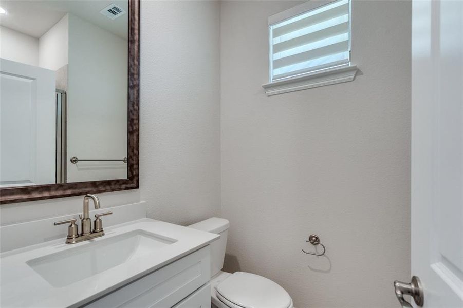 Half bathroom with vanity and toilet Half bathroom with vanity and toilet