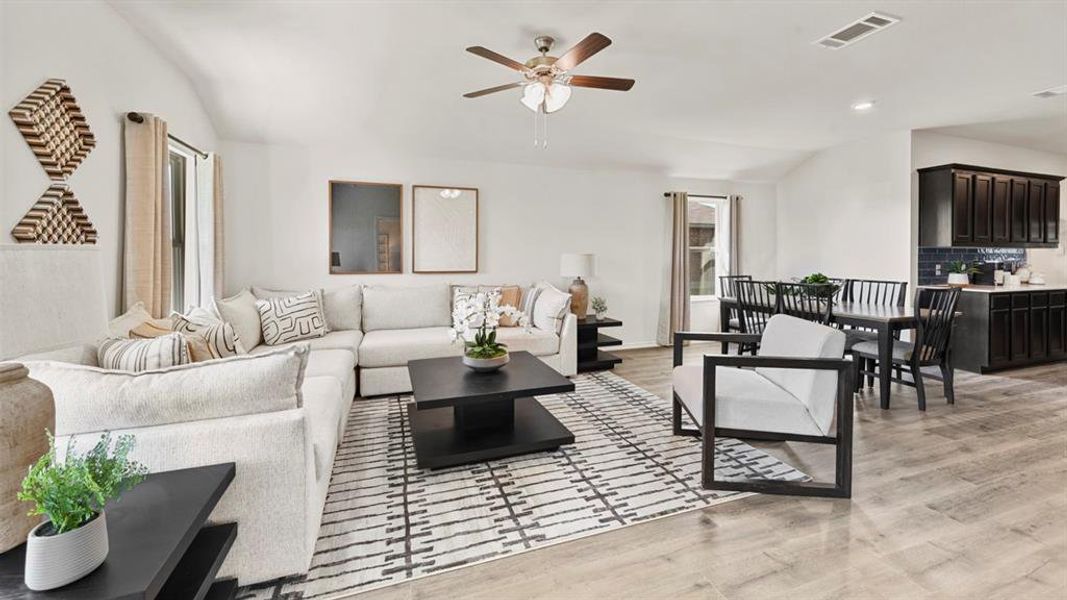 Open concept living area featuring light-colored flooring, a ceiling fan, and recessed lighting