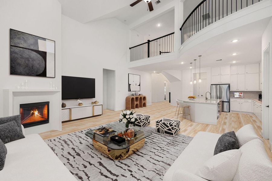 High ceilings, a contemporary fireplace, and an open layout highlight the home’s bright and airy main living space.