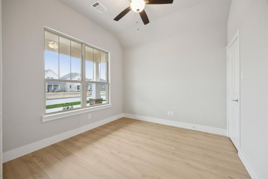 Unfurnished room with ceiling fan, lofted ceiling, and light hardwood / wood-style floors