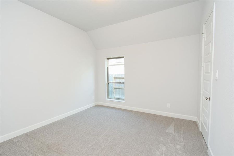 Tranquil third bedroom boasting natural light, plush carpeting, and a serene neutral palette, ready for your personal touch.