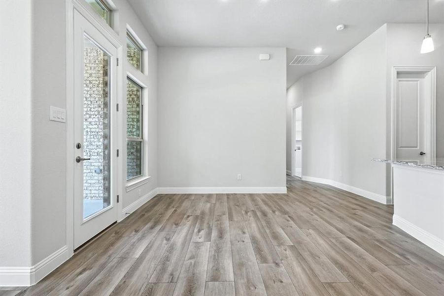 Empty room with light wood-style flooring and recessed lighting Empty room with light wood-style flooring and recessed lighting