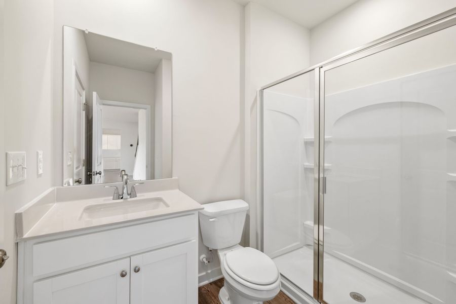 A bathroom with a glass shower. A bathroom with a glass shower.