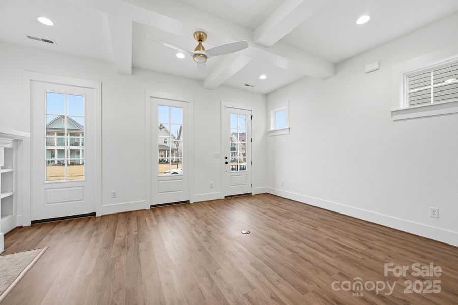 This family room is filled with natural light and showcases ceiling beams and built-in's surrounding a brick fireplace. This family room is filled with natural light and showcases ceiling beams and built-in's surrounding a brick fireplace.