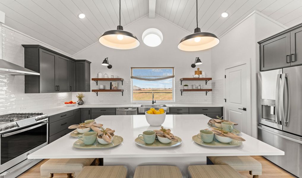 Kitchen with vaulted ceiling and pendant lighting