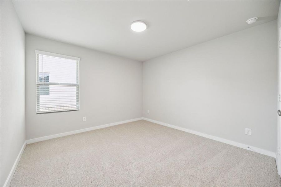 Bedroom in the Hayden home plan by Trophy Signature Homes – REPRESENTATIVE PHOTO