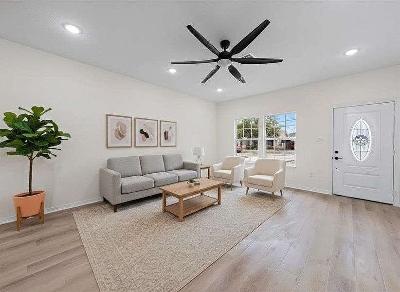 Virtually Staged Living area with light wood-type flooring, a ceiling fan, and recessed lighting