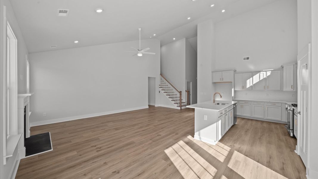 Refined and memorable, this family room features two-story ceilings and top-notch comfort throughout