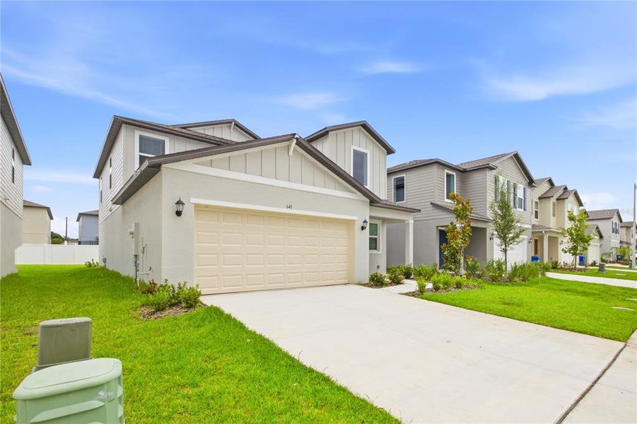 Front exterior of a new home in Cypress Point at Lake Parker, Lakeland, FL, highlighting curb appeal (Image 15). Front exterior of a new home in Cypress Point at Lake Parker, Lakeland, FL, highlighting curb appeal (Image 15).
