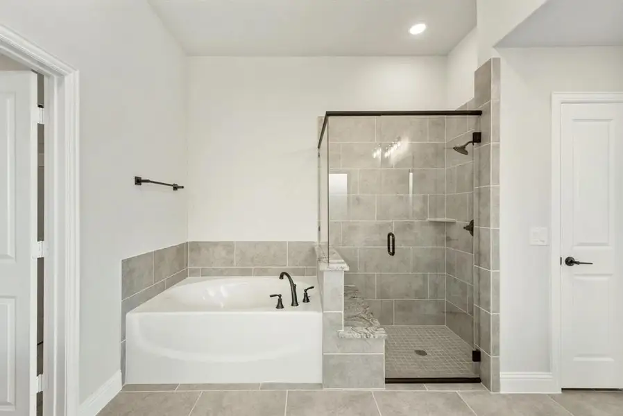 Bathroom with a soaking tub and separate glass-enclosed shower Bathroom with a soaking tub and separate glass-enclosed shower