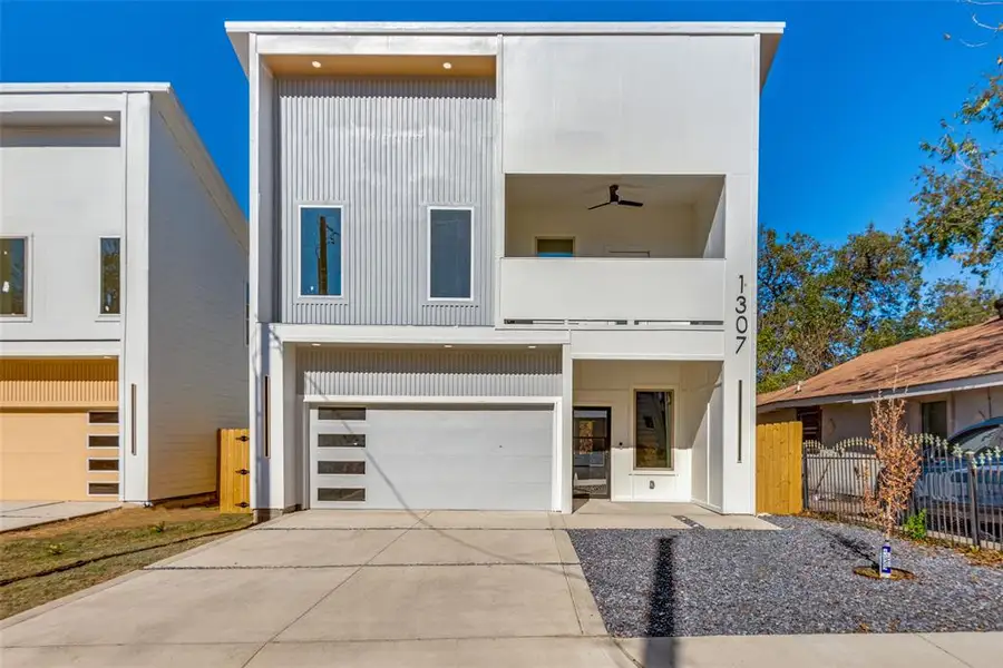 Contemporary house featuring a balcony and a garage