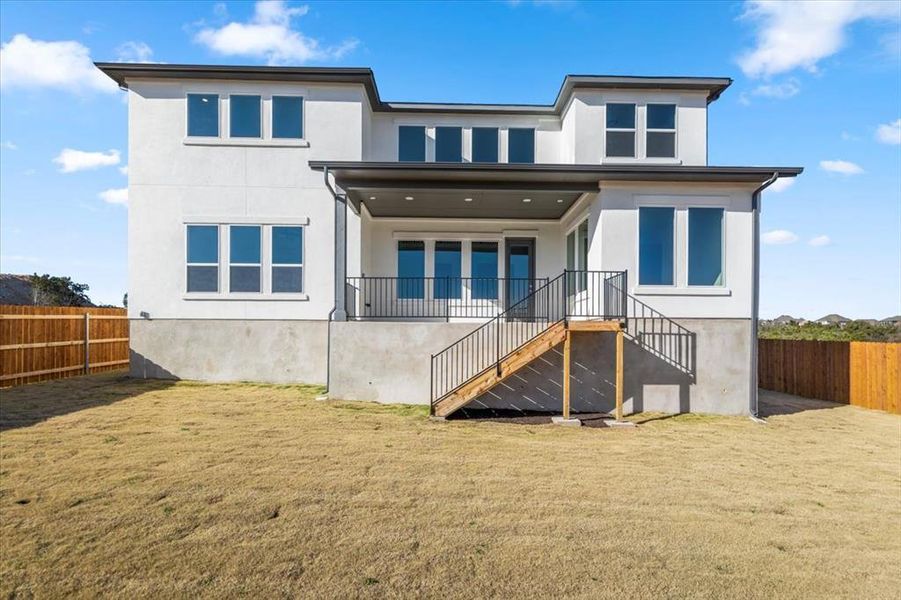 Back of property with stairs and stucco siding