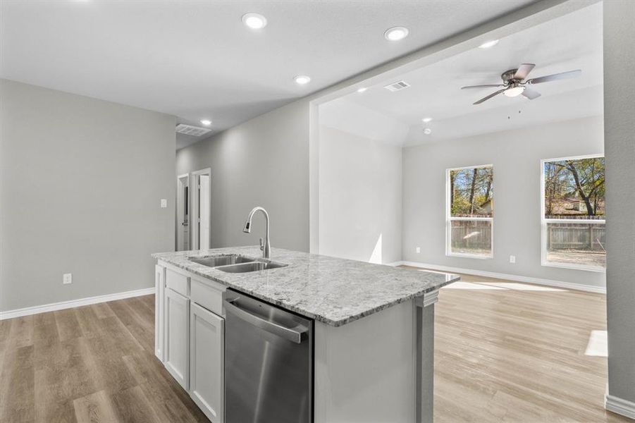 View looking to living room.  Imagine hosting family and friends here.  Everyone will be included in the conversation with this open concept the conversation will flow.  Hallway leads to 2 other bedrooms, guest bath and primary.