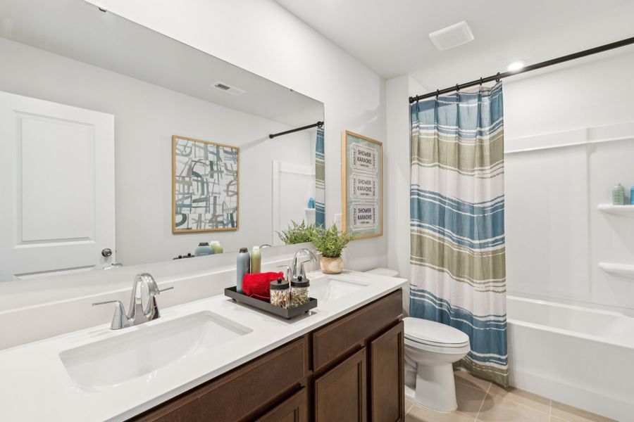 A bathroom with a tub sink and toilet. A bathroom with a tub sink and toilet.