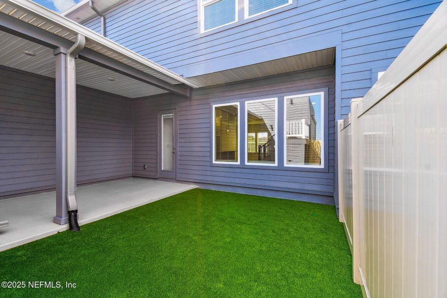 Front exterior of a new home in Seven Pines 24' Rear Entry Townhomes, Jacksonville, FL, highlighting curb appeal (Image 17).