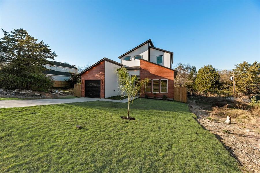 View of front of house with concrete driveway and an attached garage View of front of house with concrete driveway and an attached garage