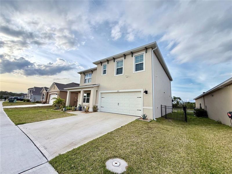 Front exterior of a new home in Harmony West, St. Cloud, FL, highlighting curb appeal (Image 28).