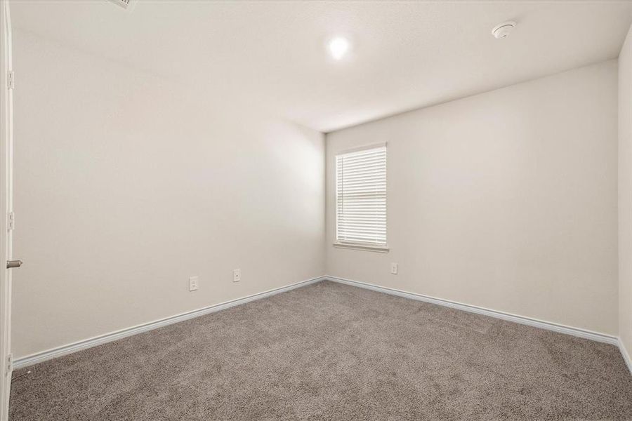 Bedroom featuring carpet flooring and baseboards Bedroom featuring carpet flooring and baseboards