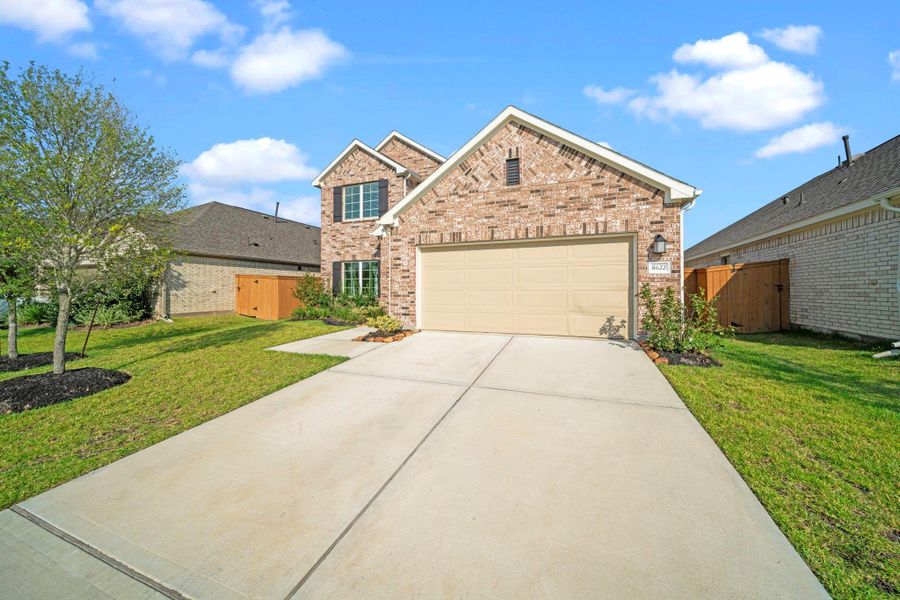 Front exterior of a new home in Marvida, Cypress, TX, highlighting curb appeal (Image 25). Front exterior of a new home in Marvida, Cypress, TX, highlighting curb appeal (Image 25).