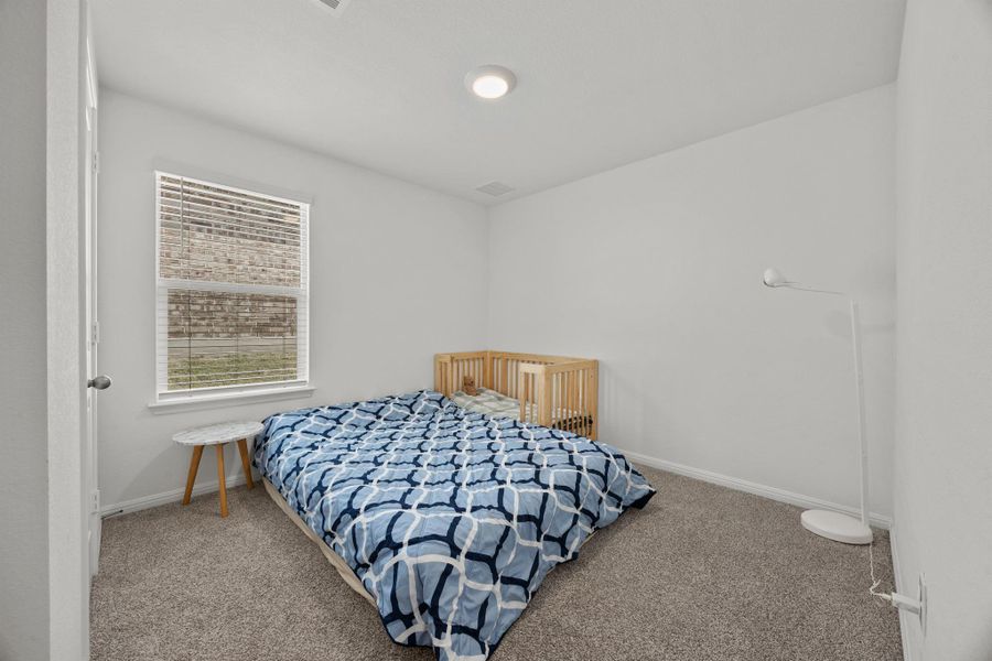 Carpeted bedroom with baseboards
