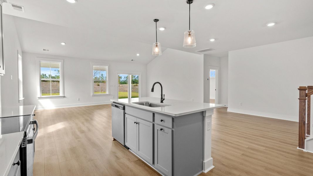 Bright open-concept kitchen and living space with durable LVP floors.