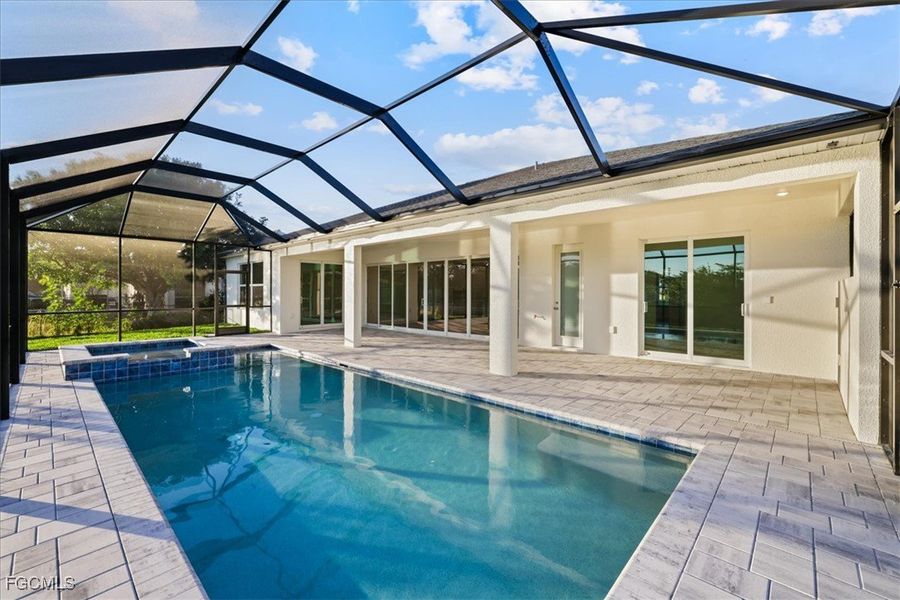 View of pool with a sunroom, a lanai, a patio area, and a pool with connected hot tub