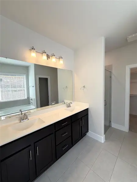 Stylish ensuite with dual vanities designed for comfort & convenience.