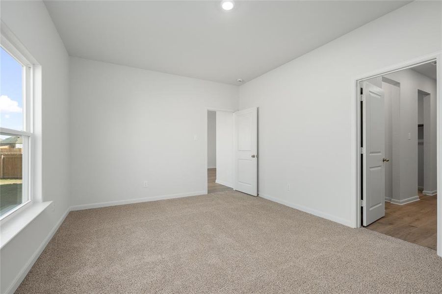 Unfurnished bedroom featuring light colored carpet